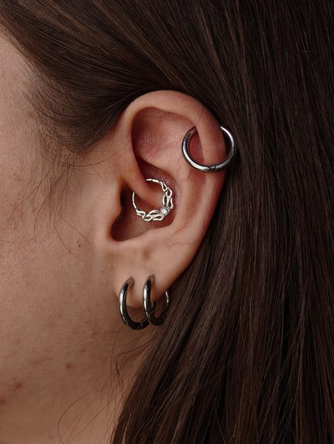 Ear with a daith ring, helix hoop and double lobe hoops