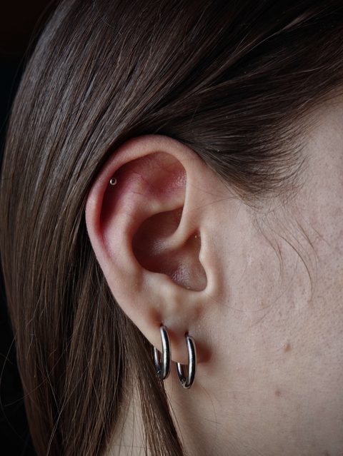 Ear with a small helix stud and double lobe hoops